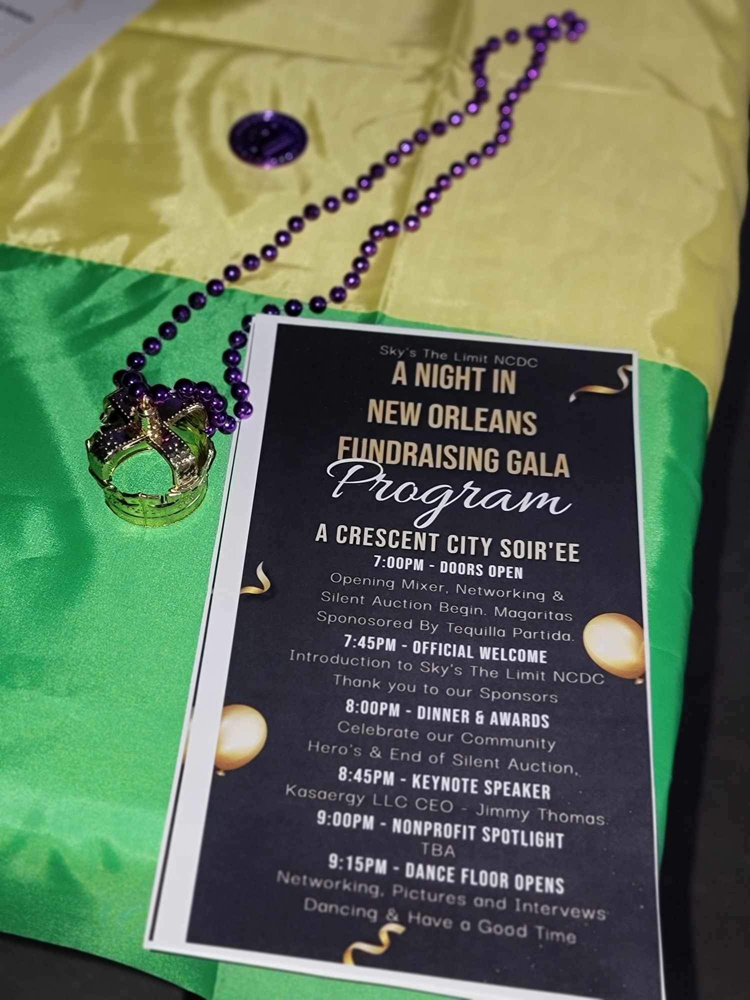 Crescent City Soirée gala program with Mardi Gras beads
